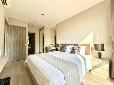 a bedroom with a large white bed in a room at Bright & Spacious Apartment - Asoke in Bangkok
