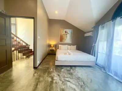 a bedroom with a white bed and a staircase at Bangkok Phomphong Villa\u8054\u6392\u6cf0\u5f0f\u522b\u5885 in Bangkok