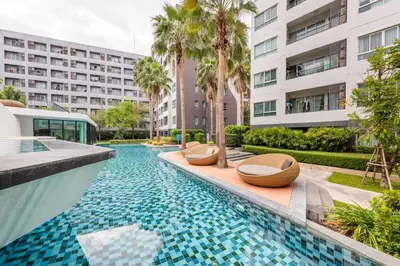 a swimming pool with chairs and a building at Elio Del Ray Studio walk to BTS in Bangkok