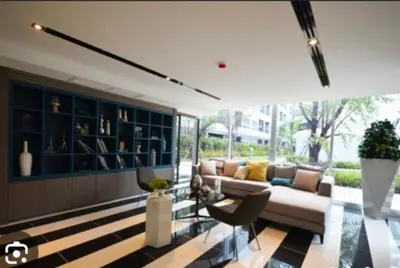 a living room with a couch and some chairs at Elio Del Ray Studio walk to BTS in Bangkok