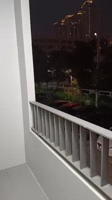 a view of a city at night from a balcony at Elio Del Ray Studio walk to BTS in Bangkok