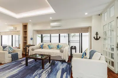 a living room with a couch and a table at Luxurious 6BR Villa with Pool & Games at Sukhumvit in Bangkok