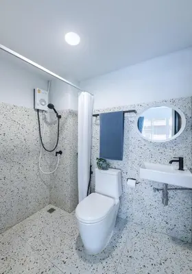 a bathroom with a toilet and a sink at Petchaburi22 Apartments next to Platinum mall in Bangkok