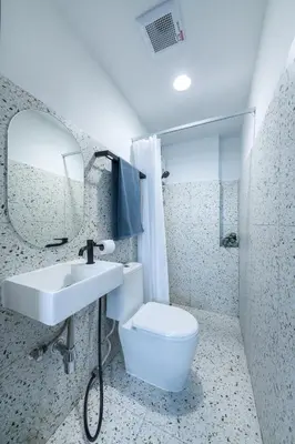 a bathroom with a sink and a toilet and a mirror at Petchaburi22 Apartments next to Platinum mall in Bangkok