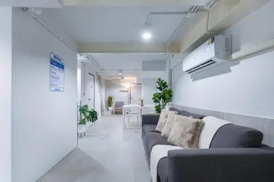 a living room with a couch and a table at Petchaburi22 Apartments next to Platinum mall in Bangkok