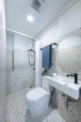 a bathroom with a toilet and a sink at Petchaburi22 Apartments next to Platinum mall in Bangkok