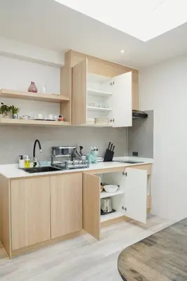 a kitchen with wooden cabinets and a sink at Somewhere house in Bangkok