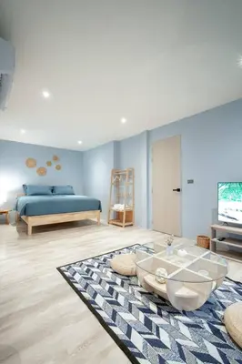 a living room with a bed and a coffee table at Somewhere house in Bangkok