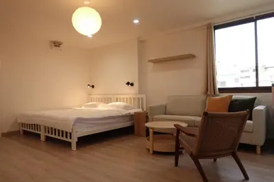 a bedroom with a bed and a couch and a chair at 24 Apt in Bangkok