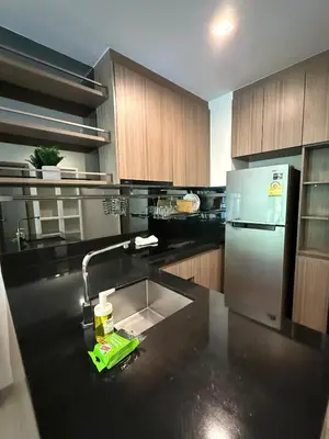 a kitchen with a sink and a refrigerator at City Heaven - Coowork - Gym - BTS - Pool - Mall - Starbucks - ShoppingMall in Bangkok
