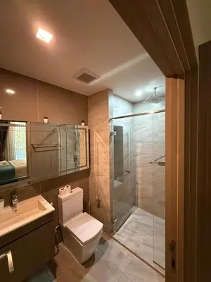 a bathroom with a shower and a toilet and a sink at City Heaven - Coowork - Gym - BTS - Pool - Mall - Starbucks - ShoppingMall in Bangkok