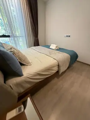 a large bed in a room with a window at City Heaven - Coowork - Gym - BTS - Pool - Mall - Starbucks - ShoppingMall in Bangkok