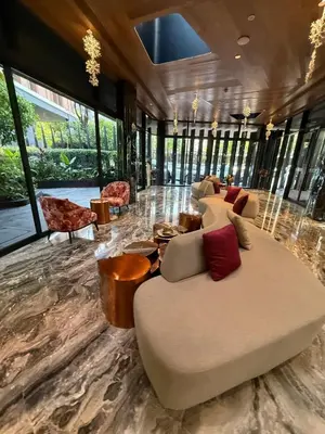 a large living room with a large couch and chairs at City Heaven - Coowork - Gym - BTS - Pool - Mall - Starbucks - ShoppingMall in Bangkok