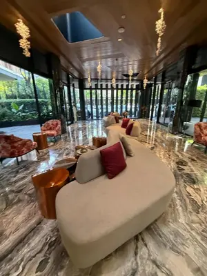 a living room with a large couch in the middle at City Heaven - Coowork - Gym - BTS - Pool - Mall - Starbucks - ShoppingMall in Bangkok
