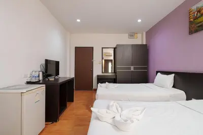 a hotel room with two beds and a television at Collection O Khaosan Park in Bangkok