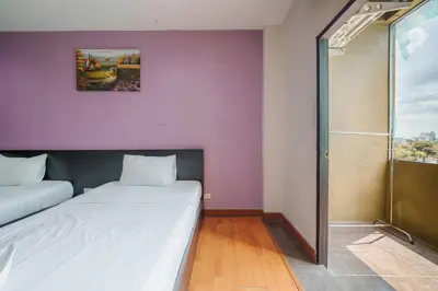 a small room with two beds and a shower at Collection O Khaosan Park in Bangkok