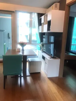 a living room with a table and a kitchen with a tableablish at CozyroomSukumvit13walktoBTS,MRT in Bangkok