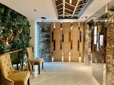 a lobby with a glass table and a large plant at CozyroomSukumvit13walktoBTS,MRT in Bangkok