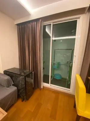 a living room with a large window and a couch at CozyroomSukumvit13walktoBTS,MRT in Bangkok