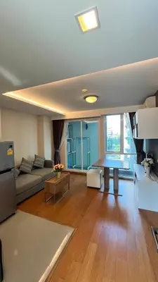 a living room with a couch and a table at CozyroomSukumvit13walktoBTS,MRT in Bangkok