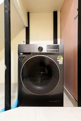 a black washer and dryer in a room at OH Homes - Samsen 10 in Bangkok
