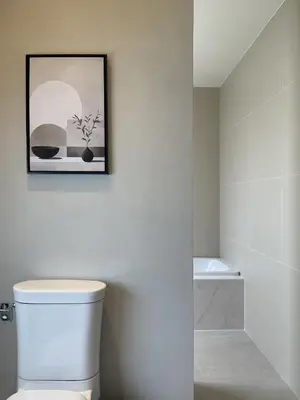 a bathroom with a toilet and a picture on the wall at Chinatown Heritage, Chinatown Main road in Samphanthawong
