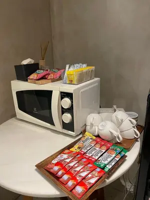 a microwave sitting on top of a table at Chinatown Heritage, Chinatown Main road in Samphanthawong
