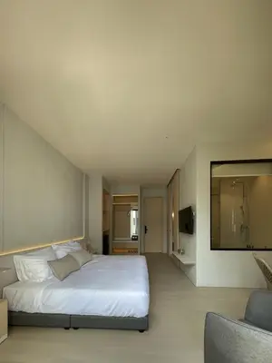 a bedroom with a large white bed and a couch at Chinatown Heritage, Chinatown Main road in Samphanthawong