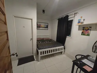 a small room with a bed in the corner at Jatujak Bangkok guesthouse R5 in Sathani Bang Su