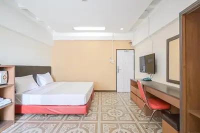 a hotel room with a bed and a television at AC Habitat Bangkok in Bangkok