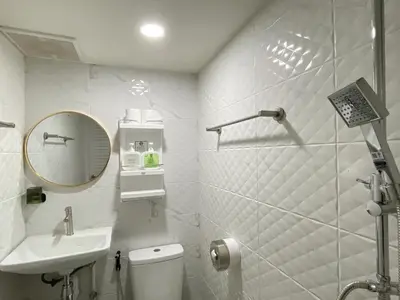 a bathroom with a toilet and a sink and a mirror at Entire house,Unwind in the city, near GrandPalace in Bangkok
