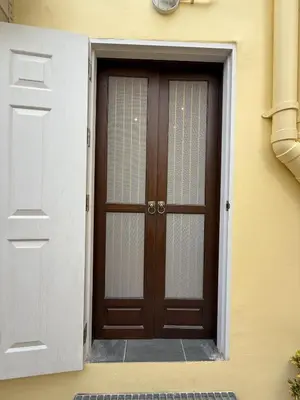 a door to a building with a door with a window at Luan Heritage Surawong in Bangkok