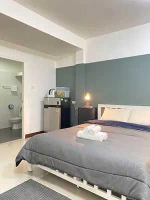 a bedroom with a bed with two towels on it at La Maison 230 in Ban Khlong Samrong