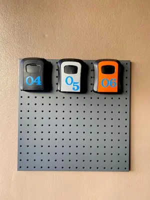 a metal wall with three monitors on it at La Maison 230 in Ban Khlong Samrong