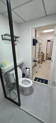 a bathroom with a toilet in a room at Homey Place in Ban Song Hong