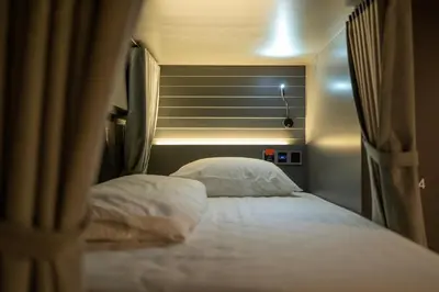 a bedroom with a bed with two pillows at The Chedee Krungthep in Bangkok