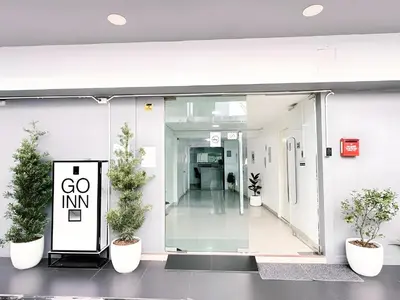 a hallway with potted plants in a building at XX GO INN BTS Nana Sukhumvit Soi 3 x โกอินน์ บีทีเอส นานา ซอย 3 in Makkasan