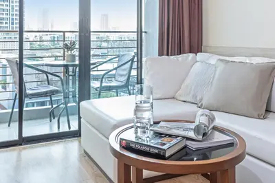 a living room with a couch and a table at Adelphi Forty-Nine in Bangkok