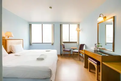 a hotel room with a bed and a desk and a mirror at xx Wish Inn Chidlom - วิช อินน์ ชิดลม ราชดำริ 2 in Pratunam