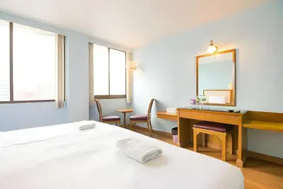 a bedroom with a bed and a desk and a mirror at xx Wish Inn Chidlom - วิช อินน์ ชิดลม ราชดำริ 2 in Pratunam