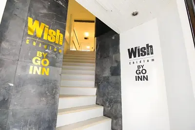 a staircase in a building with signs on the wall at xx Wish Inn Chidlom - วิช อินน์ ชิดลม ราชดำริ 2 in Pratunam