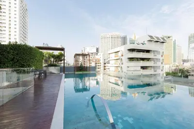 a swimming pool in the middle of a city at 2 Bedrooms, Downtown BKK, BTSAsok, Sukhumvit in Bangkok