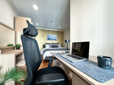 a bedroom with a desk with a laptop and a bed at Upscale Expansive 2BR - Ultra Fast Wifi - Phrom Phong in Bangkok
