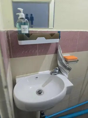 a bathroom with a white sink and a mirror at 209 Beautiful and Cozy apartment near skytrain & WiFi in Bangkok