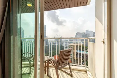 a balcony with a chair and a view of the city at 2Br, Good view, BTS Chitlom, BKK in Bangkok