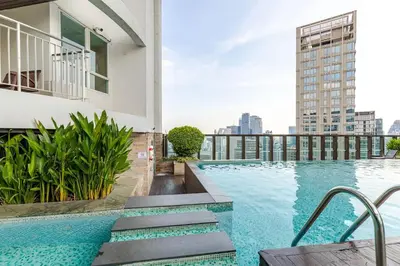 a swimming pool on the roof of a building at Large room with 2Beds BTS Chitlom Sukhumvit BKK in Bangkok
