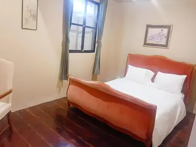 a bedroom with a bed and a window at Rest Inn China Town - Yaowarat BKK in Samphanthawong