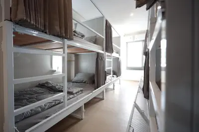 a row of bunk beds in a room at Risa Hostel - Female Only for Solo Travelers in Bangkok
