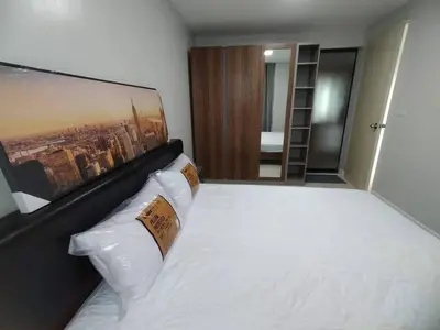 a bedroom with a large bed with white sheets and pillows at MeStlye BangNa - Baan Win in Bangna