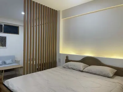 a bedroom with a large bed and a window at Dime Rama III in Bangkok